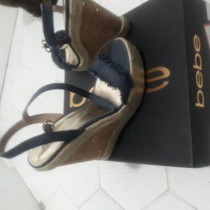 Denium wedge sandal with tag on the bottom of shoe.
